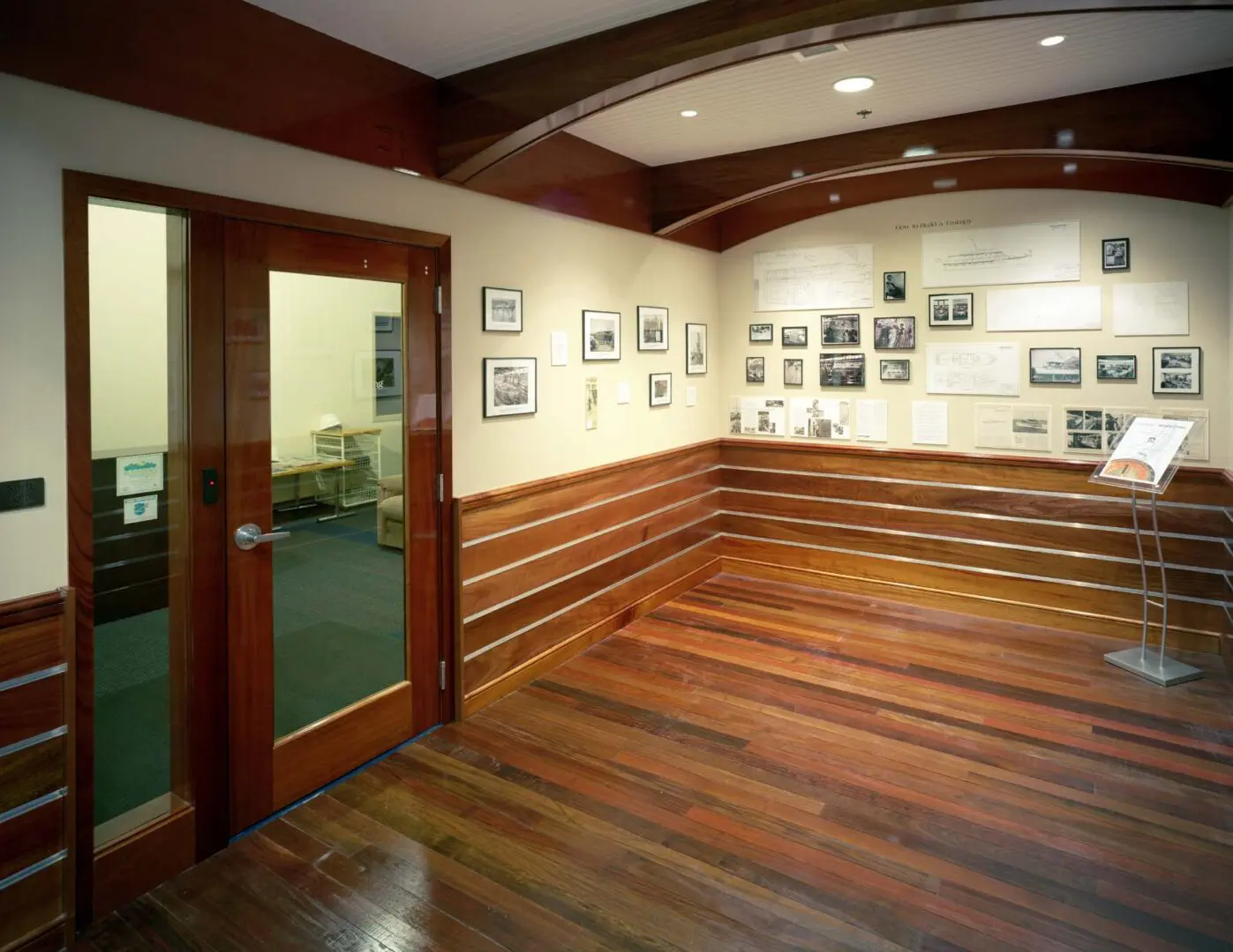 Rich mahogany half walls line the maritime-themed 2nd Floor Lobby and history museum located in the class A office building at 222 Severn.