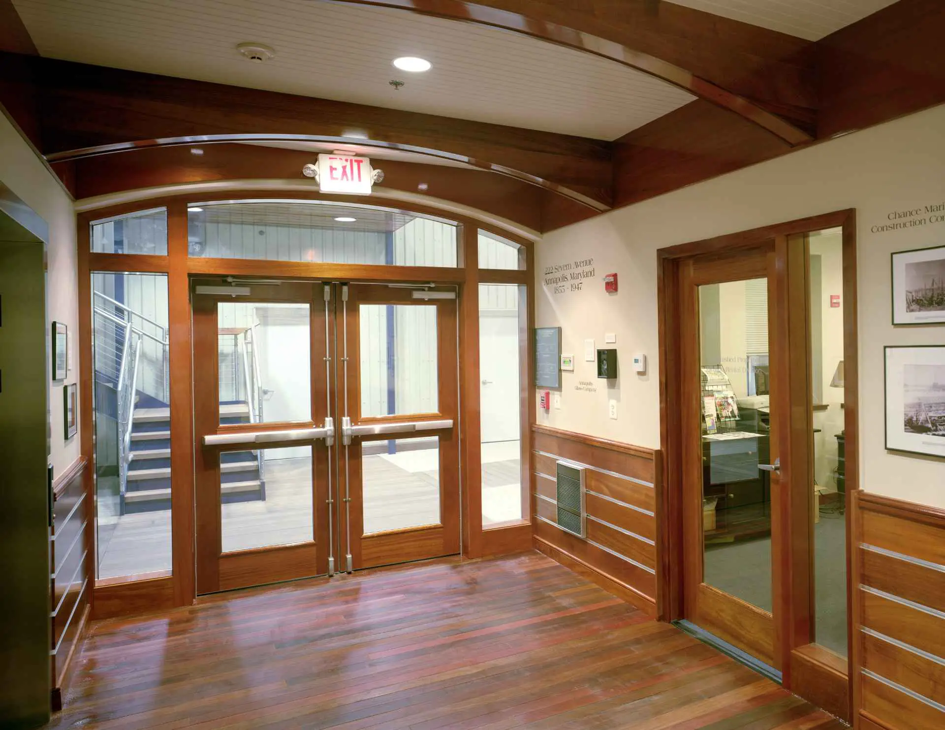 Beautiful 222 Severn Class A office lobby with mahogany interior and museum of Trumpy boat artifacts, located on the waterfront of Spa Creek in Annapolis Maryland.
